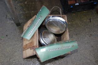 An old wooden box containing head lamps by Lucas and 'Sunbeam Talbot' panels.