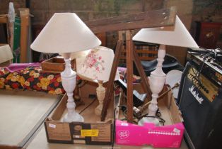 Two boxes of tall table lamps and an easel.