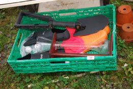 A box containing fold up spade, golf balls, flippers etc.
