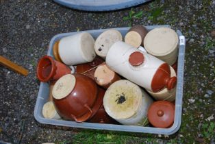 A container of bed warmers, and earthenware jars.