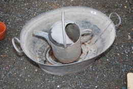 A galvanised bath and a watering can.