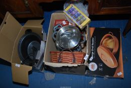 A variety of kitchenware - including a slow cooker, steamers, saucepans and a roaster.