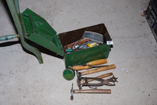 A metal Ammo box containing various tools, hammers, chisels, etc.