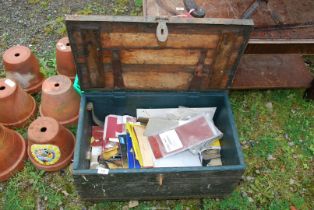 A wooden tool box containing sand paper and rubbing block.