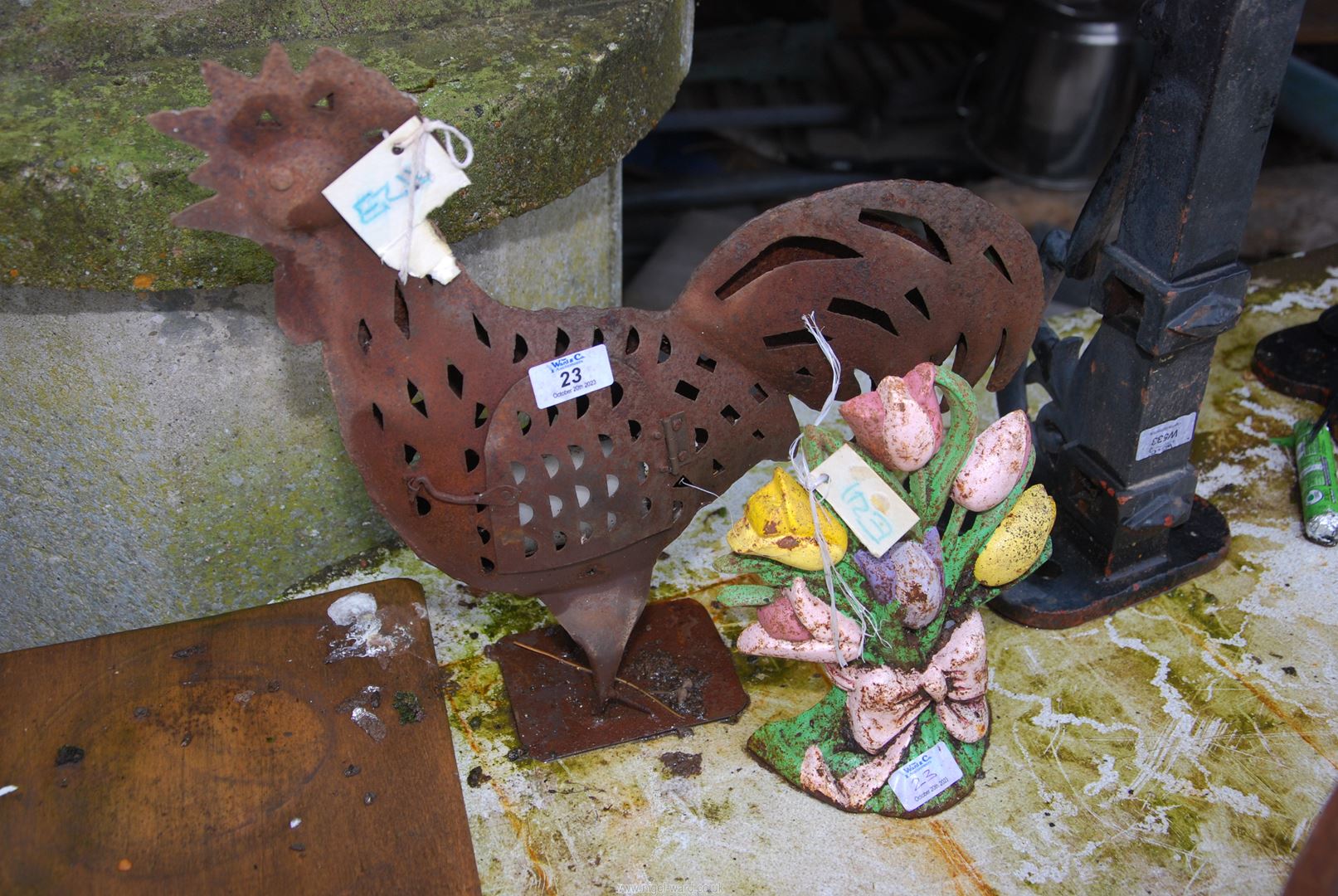 A metal Cockerel tea light and Tulip door stop.