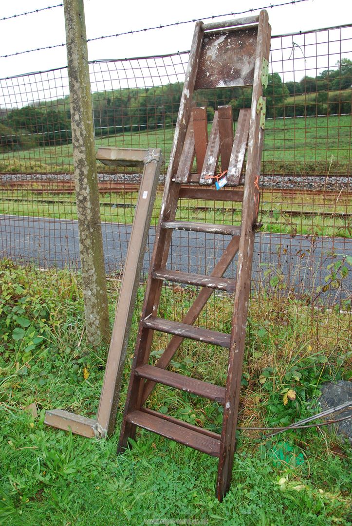 A six rung wooden step ladder, and a fire kerb.