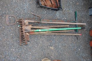 A quantity of tools - rakes, hoes and garden claws, trowels etc.