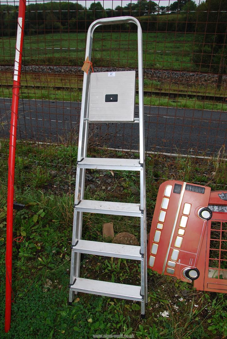 Five rung aluminum step ladder.