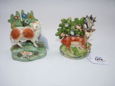 A 19 century Staffordshire figure of a lamb and ewe standing on a green base with a flowering tree