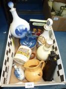 A quantity of decanters to include Delft Rosenberg Castle, Wade v Sandeman, Famous Grouse,