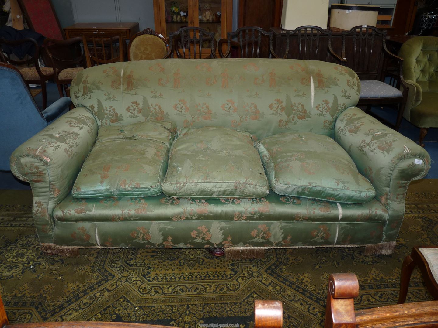 An elegant circa 1910 three-seater settee upholstered with chinoiserie style green ground satin