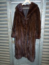A lady's dark brown Mink Coat with shawl collar and hook fastening.