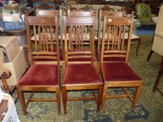 A set of six Oak framed dining chairs having maroon velvet type upholstered drop-in seats.