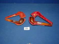 Two antique cased briar Pipes with hallmarked silver mounts and amber stems.