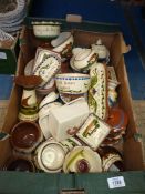 A box of Torquay ware including chamber sticks, pin trays, pudding bowls, etc.