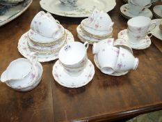 A Royal Osborne tea set for twelve (no teapot) with pink rose and gold rims decoration.