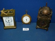 A brass Carriage clock, with key (crack to face) and two other brass clocks,