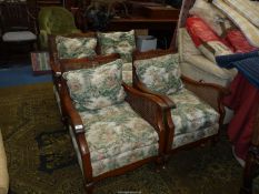 A low dark-wood framed Bergere type three piece lounge suite having caned sides and backs and