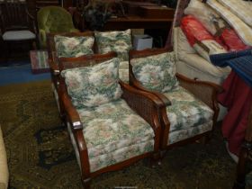 A low dark-wood framed Bergere type three piece lounge suite having caned sides and backs and