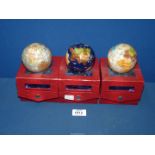 Three small mineral globe Paperweights of the world, boxed.