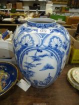 A large Chinese blue and white painted jar with reserves of prunus and bamboo and stylised border