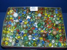 A tin of Marbles including stone, steel, white, blue, etc.