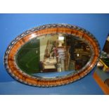 An oval bevelled Mirror, 32 1/2" wide x 22" high.