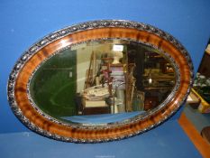 An oval bevelled Mirror, 32 1/2" wide x 22" high.