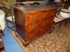 A mixed woods chest of three long drawers having cross-banded Walnut fronts and shaped back-plate