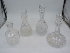 Three cut glass decanters with stoppers including Ship's,