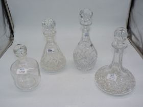 Three cut glass decanters with stoppers including Ship's,