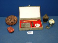A variety of Chinese items including snuff bottles, calligraphy set, etc., in a small box.
