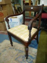 A 19th century Mahogany open-armed elbow chair having turned front legs and arm supports to the