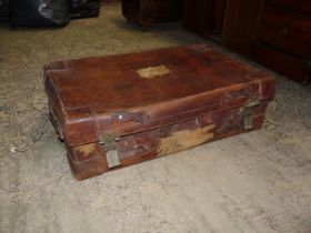 A heavy and well travelled leather suitcase for restoration, 27" x 17" x 8 3/8" high.