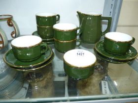 An Apilco dark green with gold decoration porcelain coffee set including six cups and saucers,