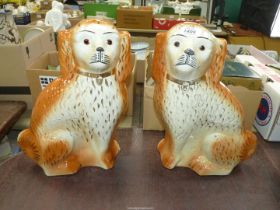 A 19th century pair of large Staffordshire mantle dogs in shades of amber with gilt highlights,