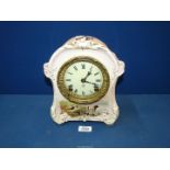 An Ansonia chiming Mantle Clock with Bonn china casing having Roman numerals to the cream face and