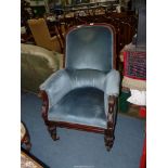 A probably 19th century dark Mahogany show framed armchair standing on turned and carved front legs