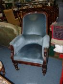 A probably 19th century dark Mahogany show framed armchair standing on turned and carved front legs
