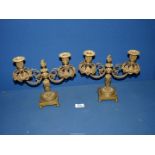 A pair of ornate and unusual cast brass double Candelabra on square weighted bases and having