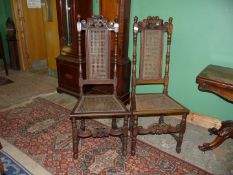 A Pair of satinwood framed side/hall chairs having caned seats and backs and standing on turned