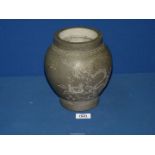 A stone vase with Oriental design, approx. 8" tall.