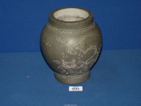 A stone vase with Oriental design, approx. 8" tall.