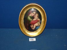 A gilt framed hand-painted porcelain plaque of Madonna Della Segiola 8" x 6 1/2" including frame,