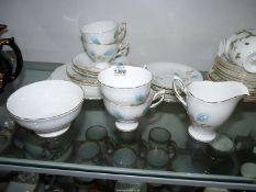 A Royal Standard part tea service with blue stylized flowers with beige leaves.