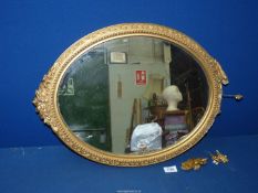A gilt framed oval wall Mirror, (frame a/f), 23" x 16 1/2".