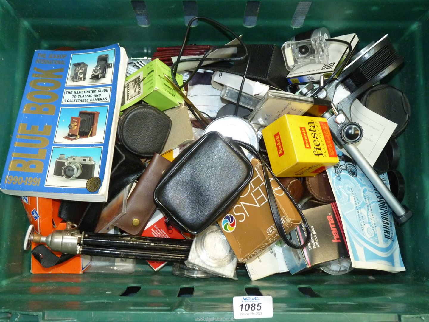 A large box of Photographic equipment including old camera parts, lenses and lens caps, etc.