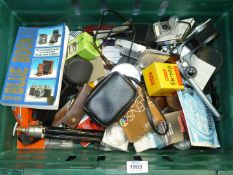 A large box of Photographic equipment including old camera parts, lenses and lens caps, etc.