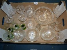A small quantity of sundae dishes, four green stemmed wine glasses, other wine glasses,