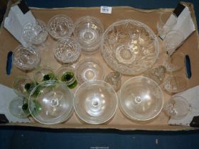 A small quantity of sundae dishes, four green stemmed wine glasses, other wine glasses,